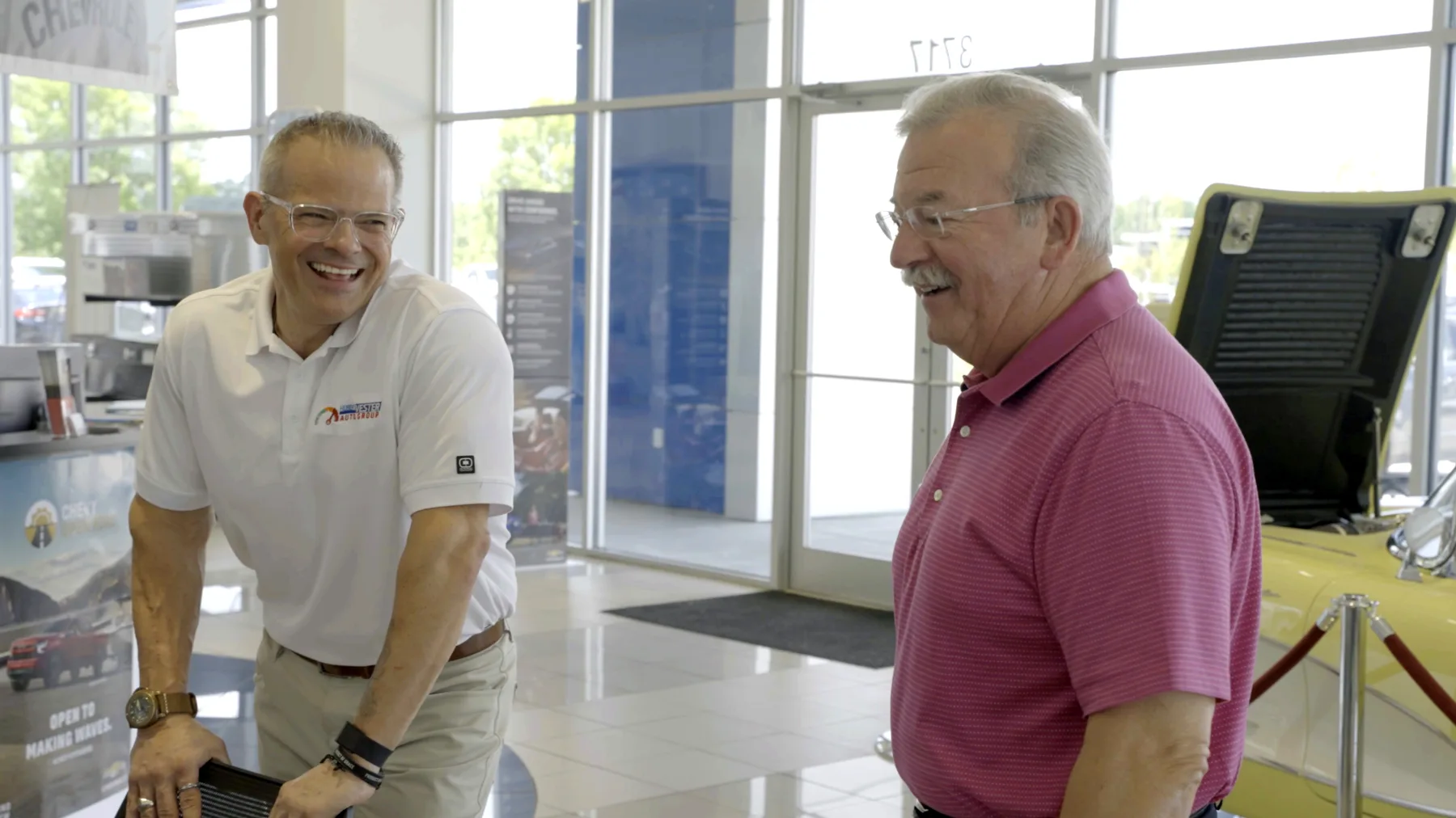 Members of the Hubert Vester Auto Group family and team talking inside a Wilson dealership